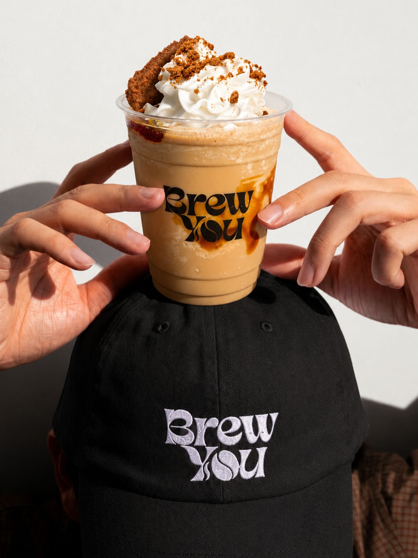 A Brew You. butterscotch frappé topped with whipped cream and biscuit crumble